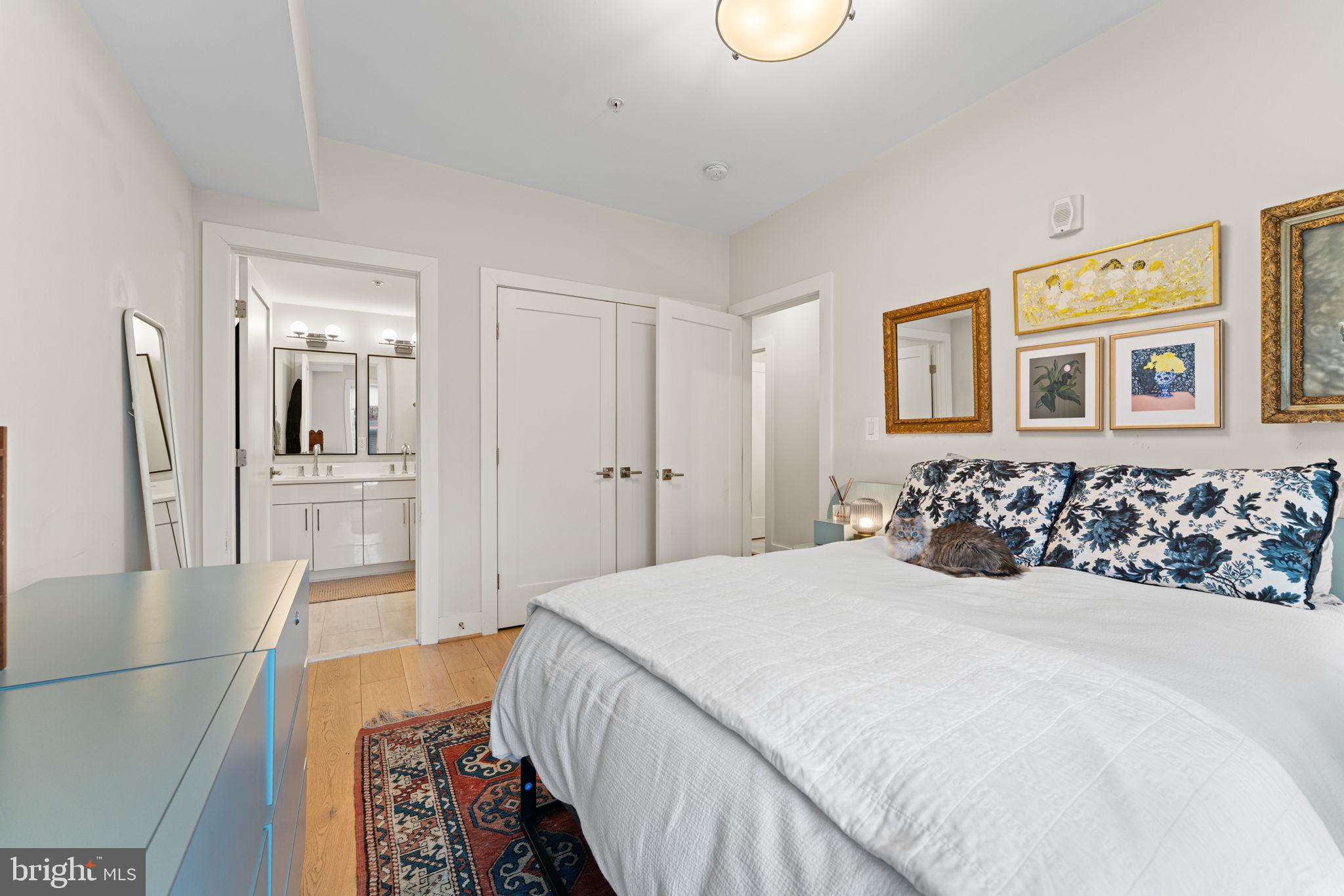 3435 14th Street Northwest, Unit 3 Washington, DC 20010 - Photo 12 of 19 a bedroom with a large bed and a chandelier