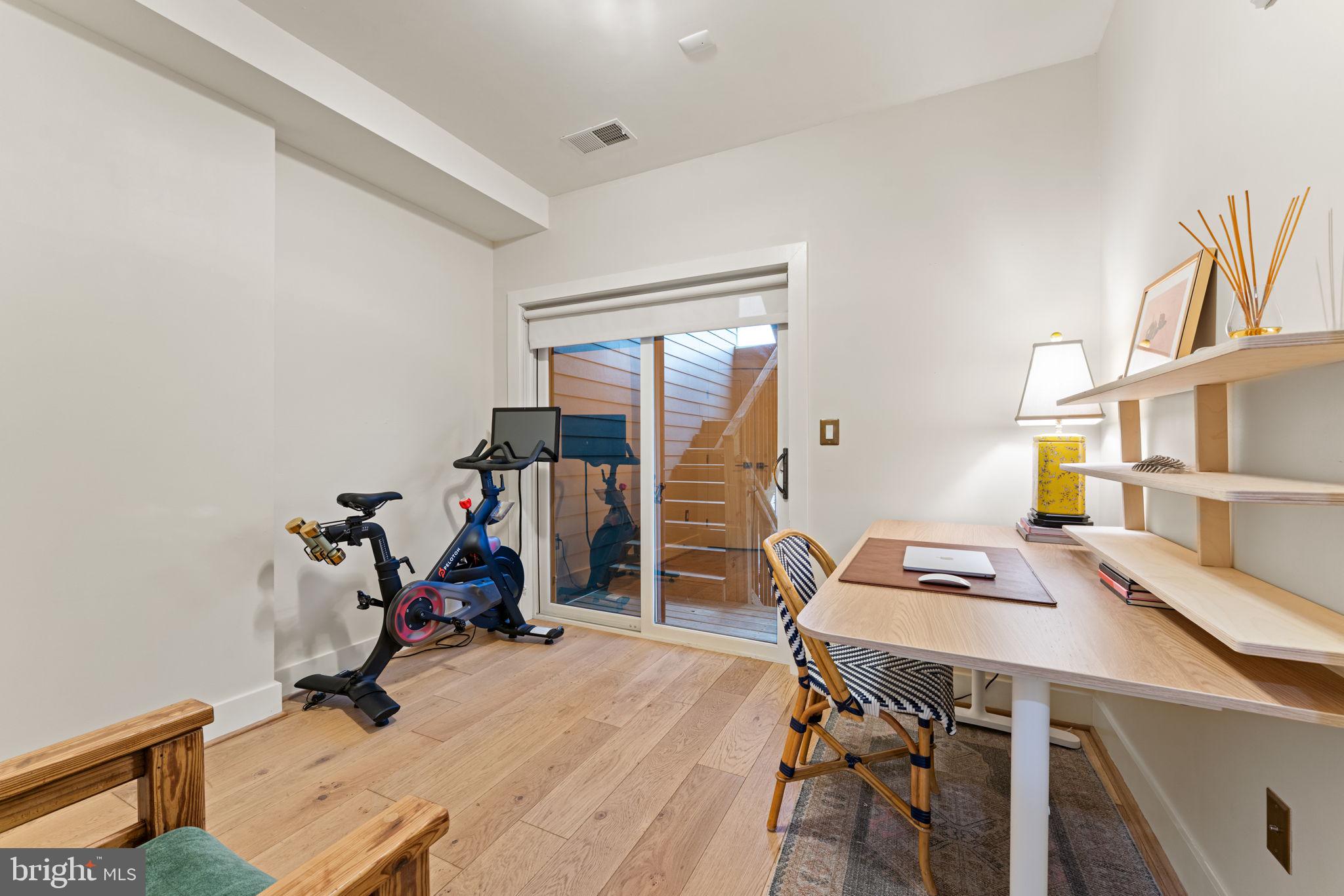 3435 14th Street Northwest, Unit 3 Washington, DC 20010 - Photo 15 of 19 a view of a workspace with furniture and gym equipment