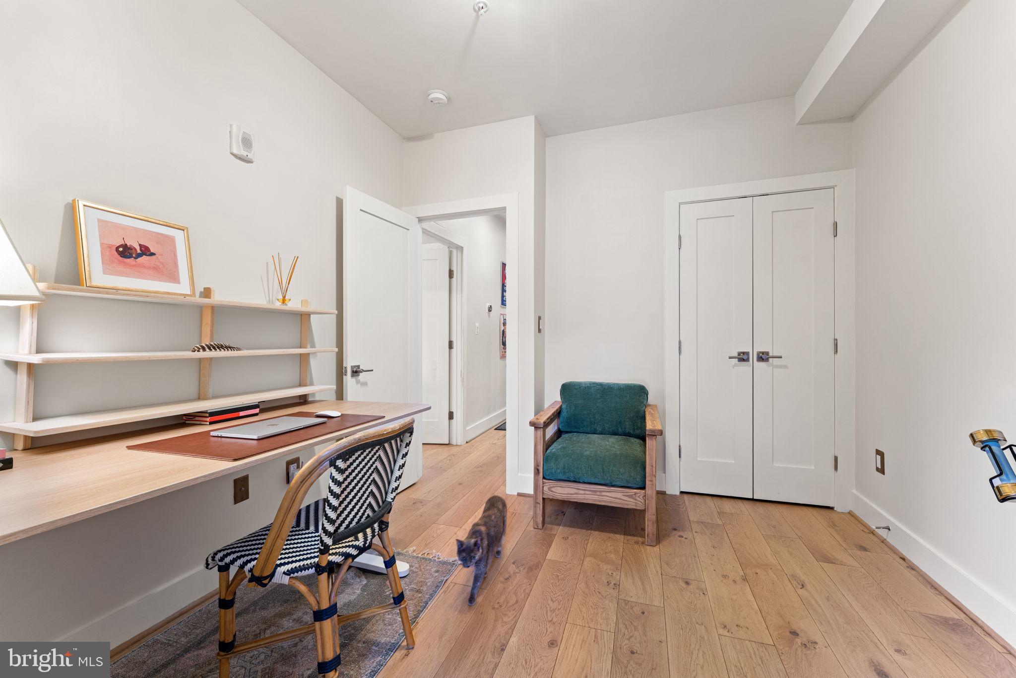 3435 14th Street Northwest, Unit 3 Washington, DC 20010 - Photo 16 of 19 a hallway with wooden floor and furniture