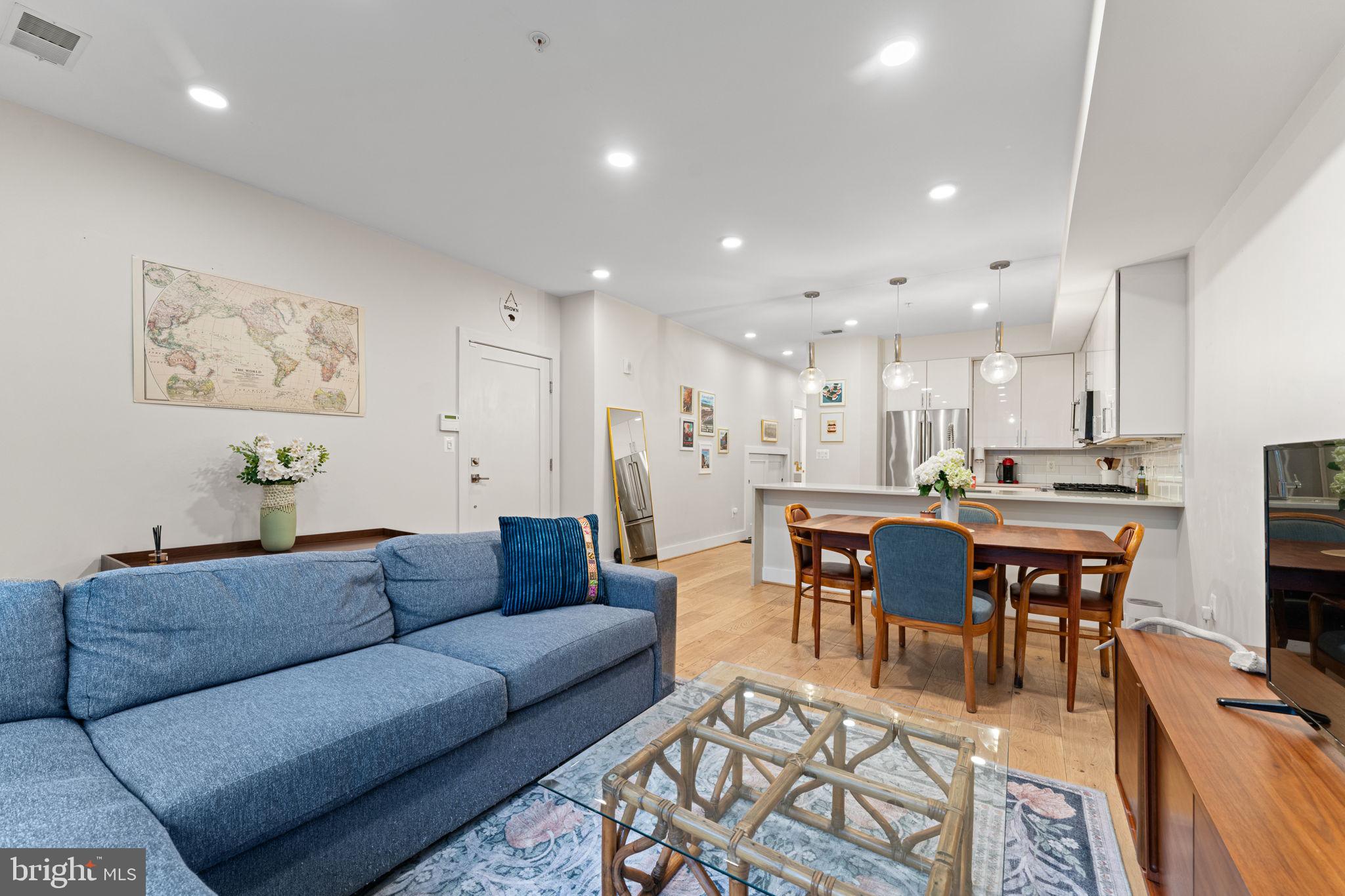 3435 14th Street Northwest, Unit 3 Washington, DC 20010 - Photo 5 of 19 a living room with furniture a dining table and kitchen view