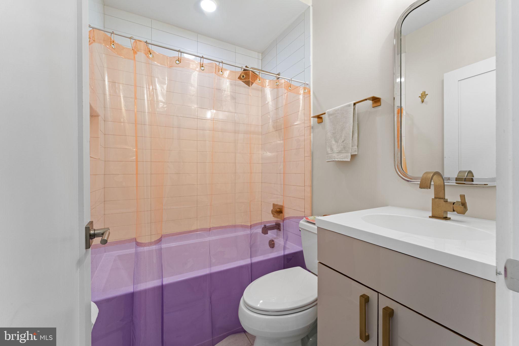 3435 14th Street Northwest, Unit 3 Washington, DC 20010 - Photo 9 of 19 a bathroom with a sink a toilet and shower curtain