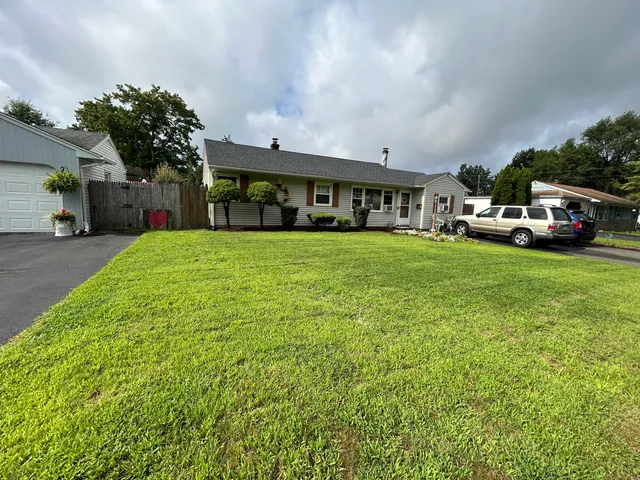 a big house with a big yard and large trees