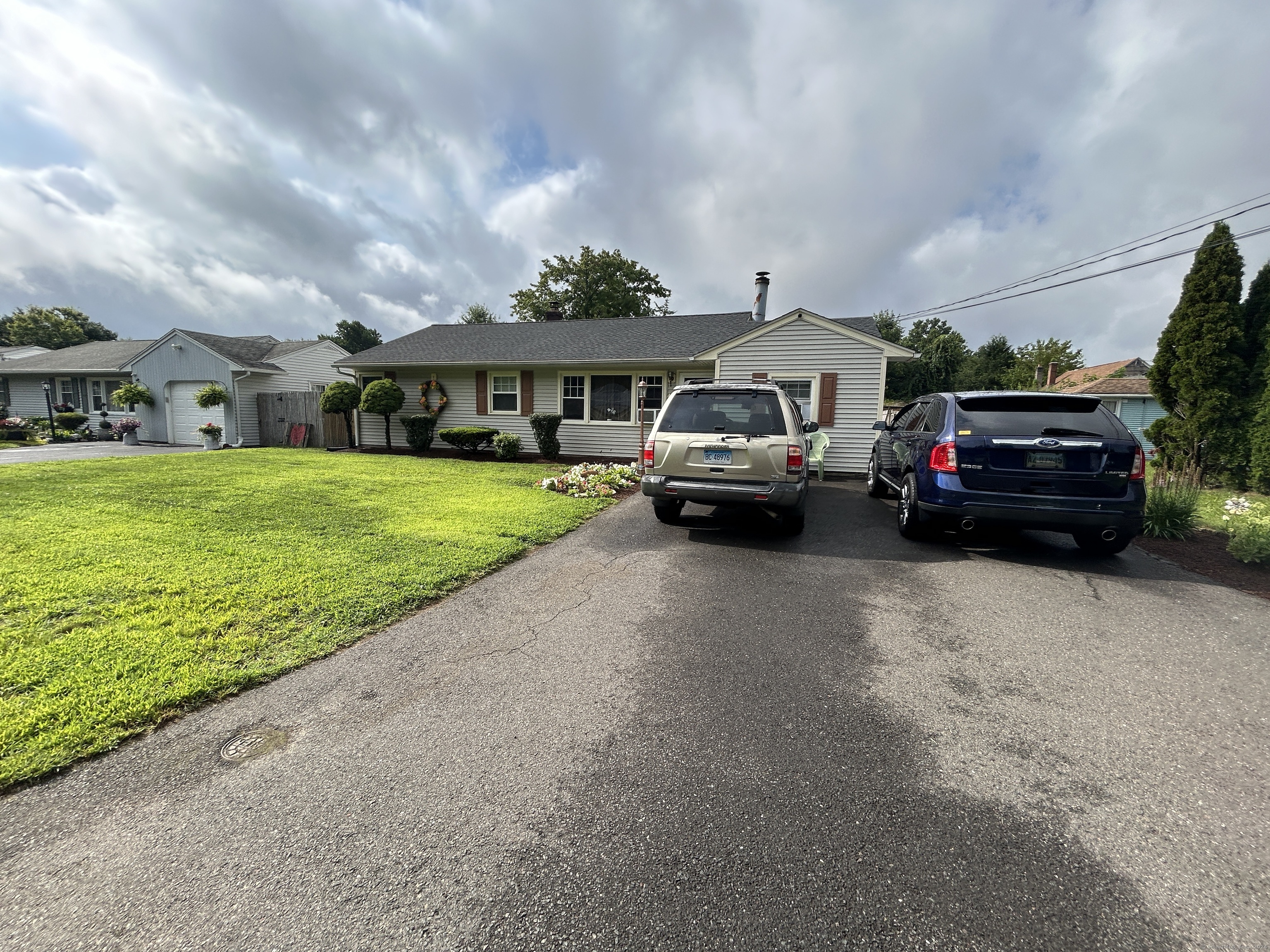 48 Plum Tree Road Plainville, CT 06062 - Photo 3 of 5 a car parked in front of the house