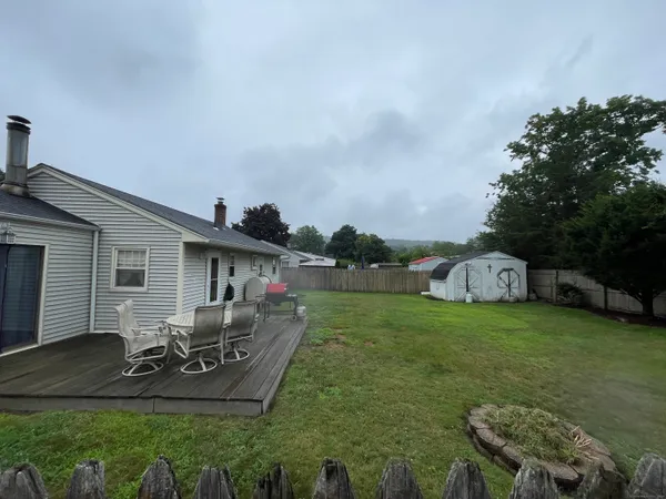a view of a house with backyard and porch