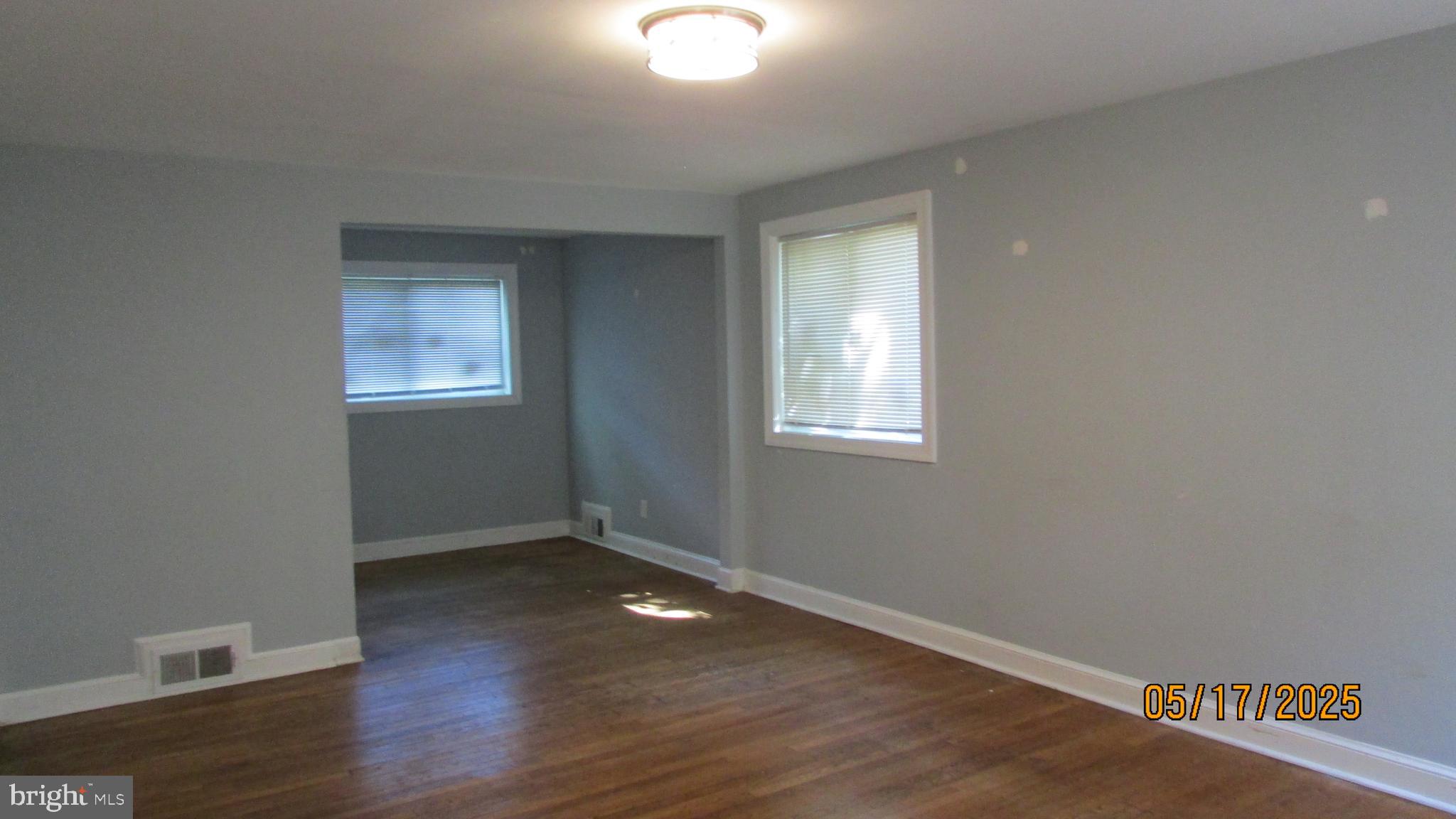 5901 Taylor Road Riverdale, MD 20737 - Photo 2 of 24 a view of an empty room with wooden floor and a window