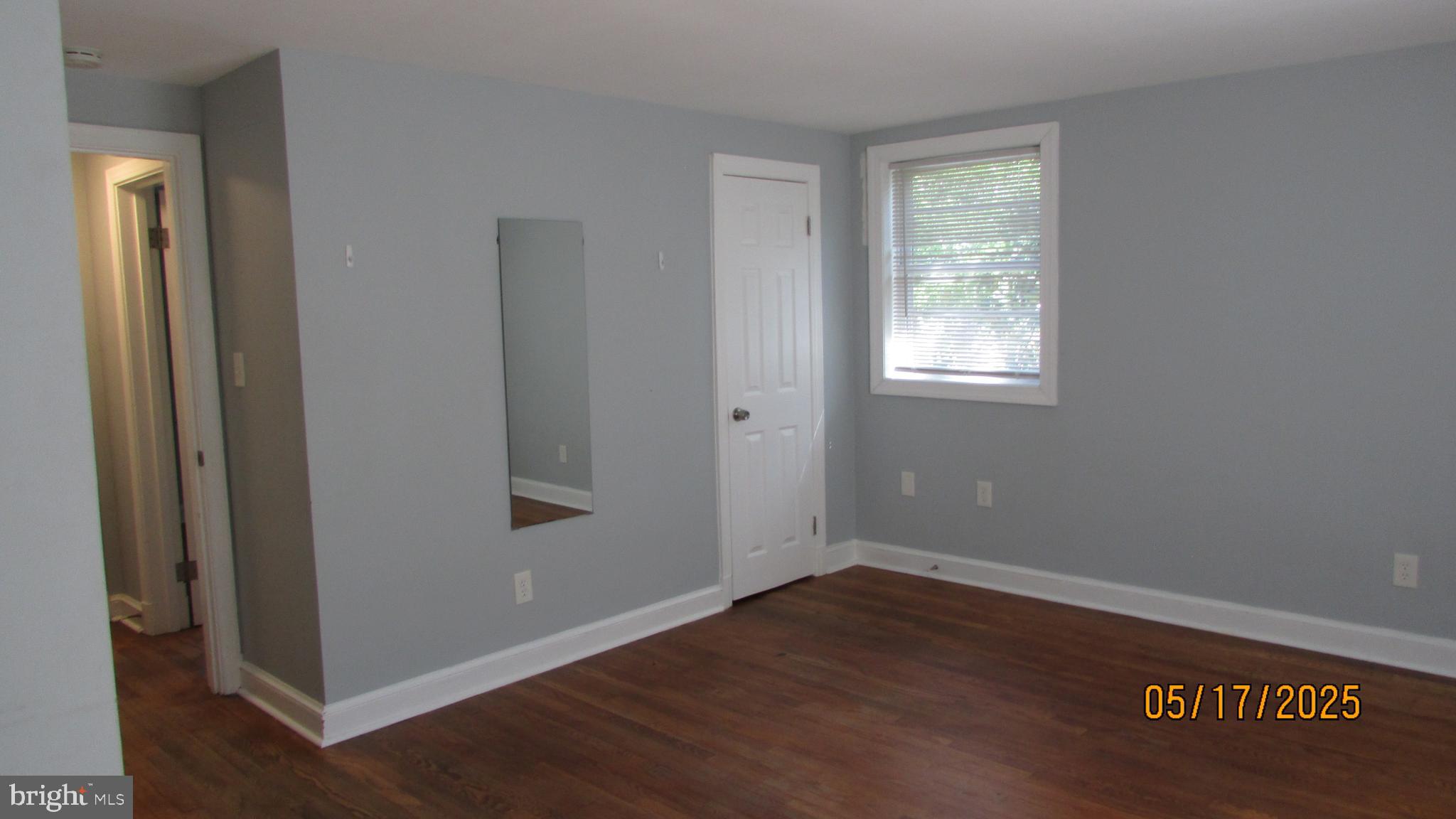5901 Taylor Road Riverdale, MD 20737 - Photo 23 of 24 an empty room with wooden floor and windows