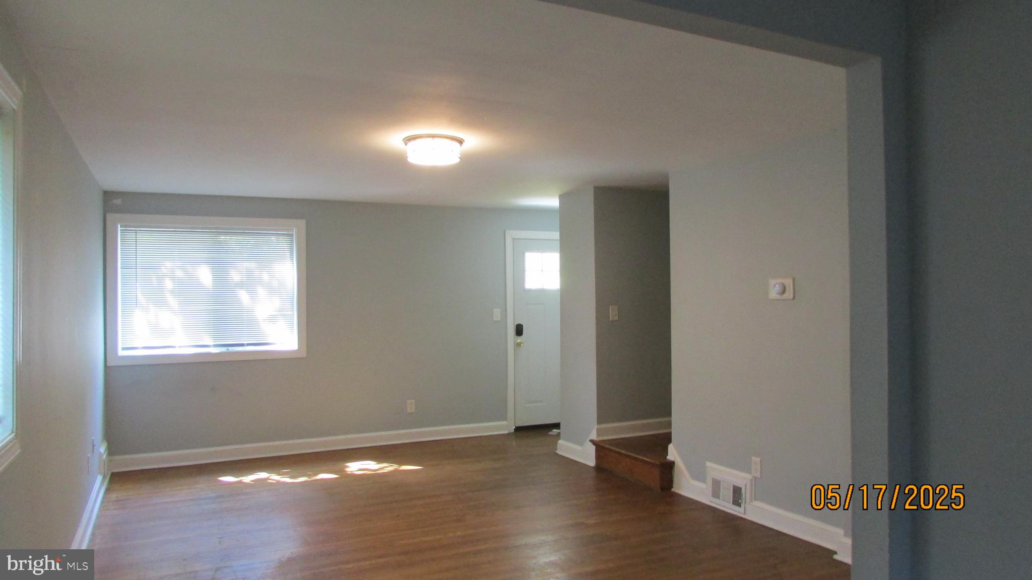 5901 Taylor Road Riverdale, MD 20737 - Photo 3 of 24 an empty room with wooden floor and windows