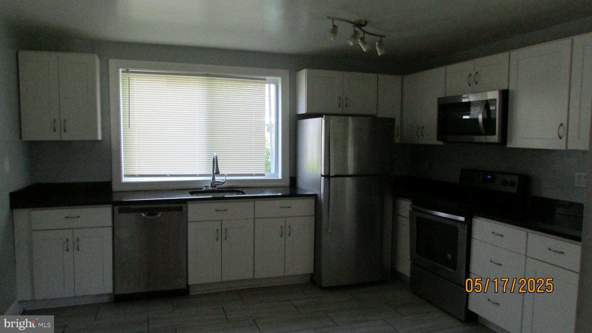 5901 Taylor Road Riverdale, MD 20737 - Photo 4 of 24 a kitchen with granite countertop a refrigerator and a sink