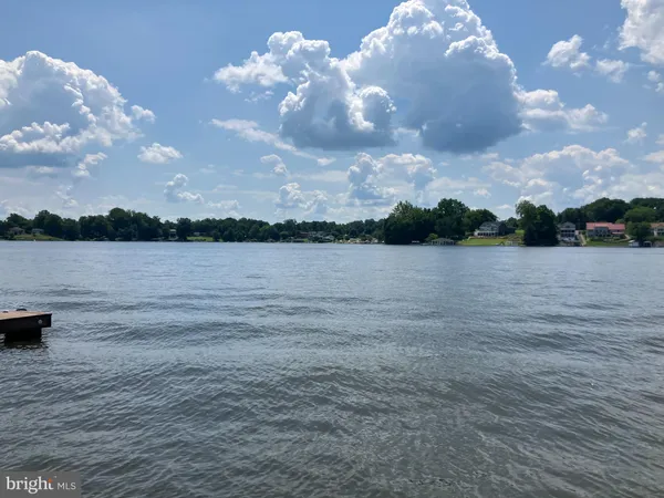 a view of a lake with a table and chairs