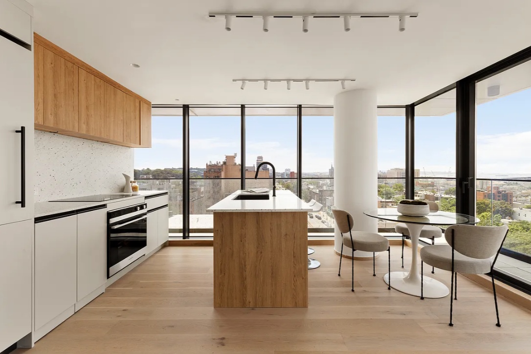 a kitchen with stainless steel appliances a stove a sink and a refrigerator