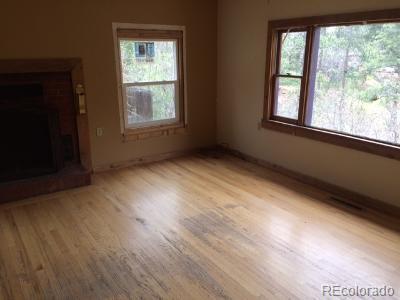 7865 Marriott Road Cascade, CO 80809 - Photo 5 of 5 an empty room with wooden floor and windows
