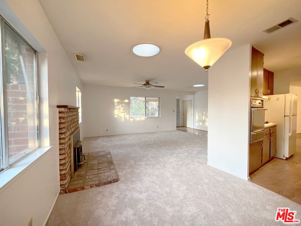 192 Valley Road Oak View, CA 93022 - Photo 4 of 34 a view of empty room with a window and fireplace