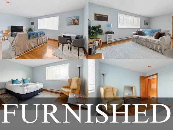 a living room with furniture and a dining table