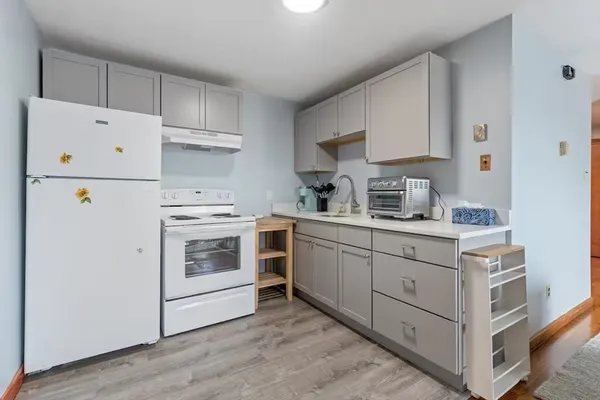 a kitchen with cabinets appliances a sink and a counter space