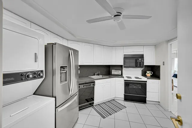 a kitchen with stainless steel appliances a refrigerator sink and stove