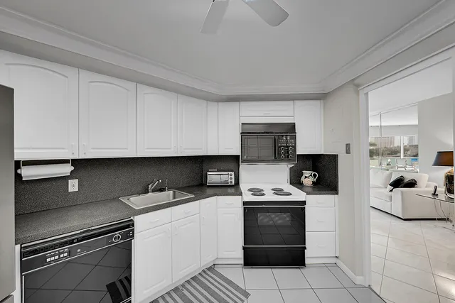 a kitchen with cabinets and steel appliances