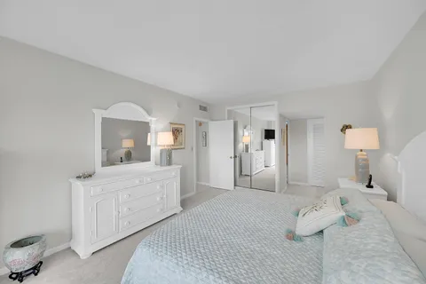 a large white bed in a white room