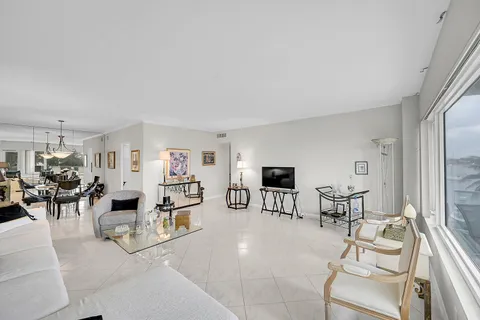 a living room with furniture a dining table and a fireplace