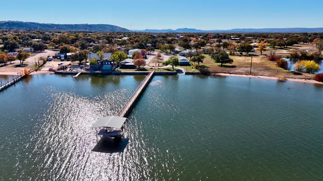 an aerial view of a houses with a lake view