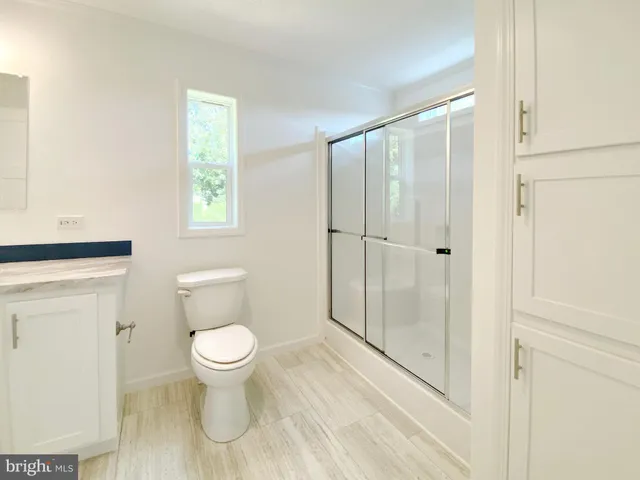 a bathroom with a toilet and a shower