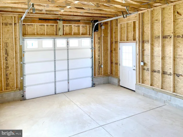 a view of a garage with wooden fence