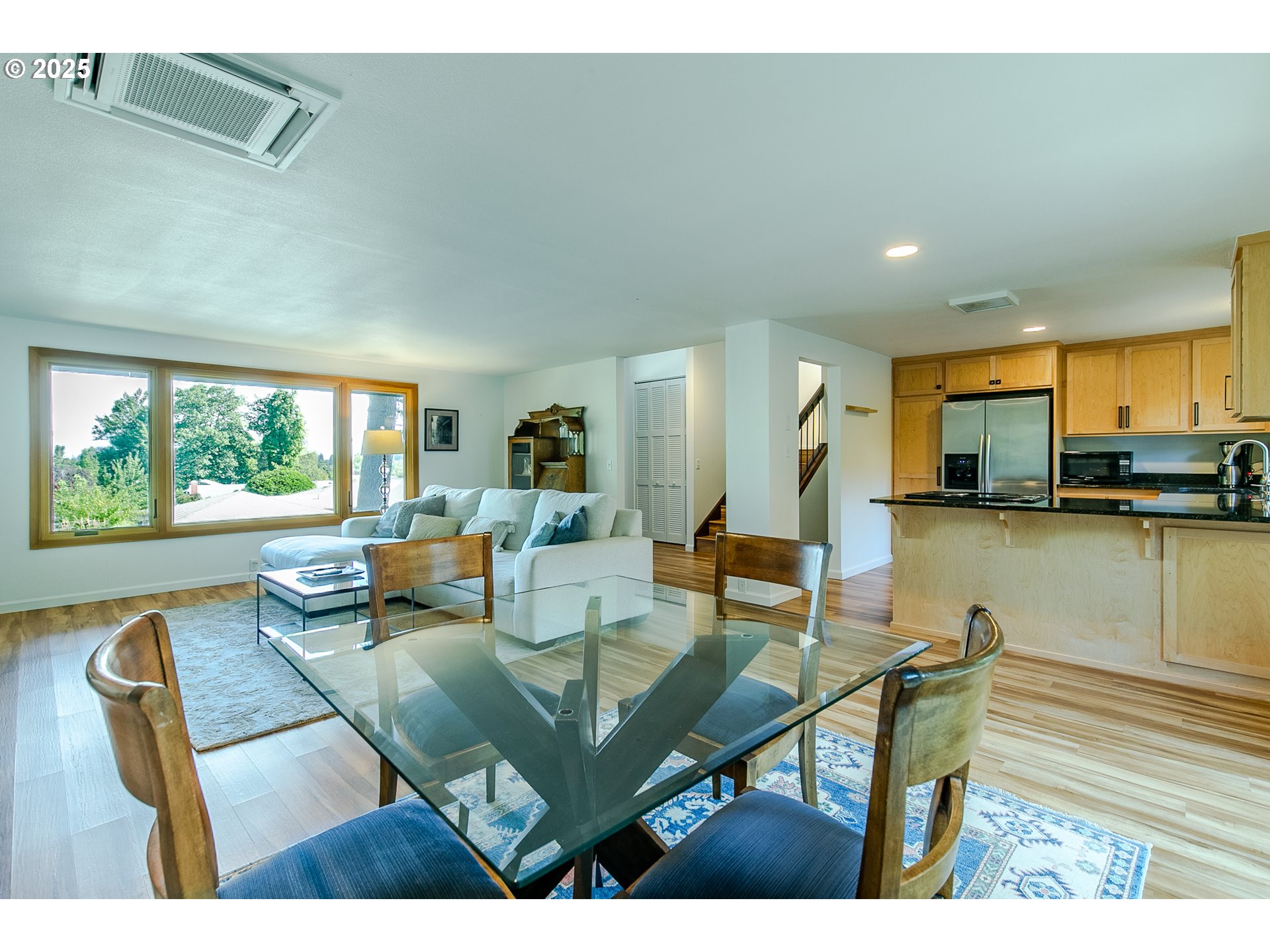 2724 Malibu Way Eugene, OR 97405 - Photo 11 of 48 a living room with furniture a flat screen tv and a large window
