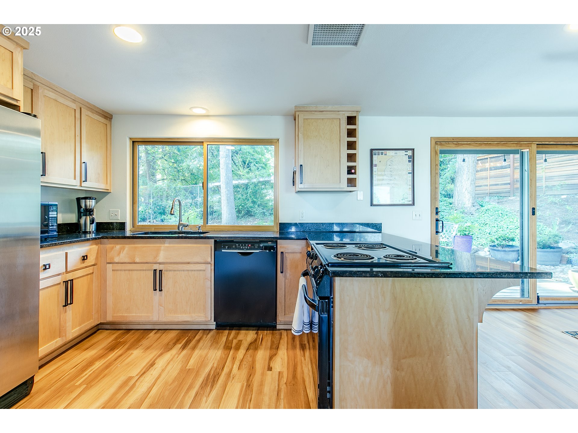 2724 Malibu Way Eugene, OR 97405 - Photo 17 of 48 a kitchen with stainless steel appliances granite countertop a stove a sink and a microwave