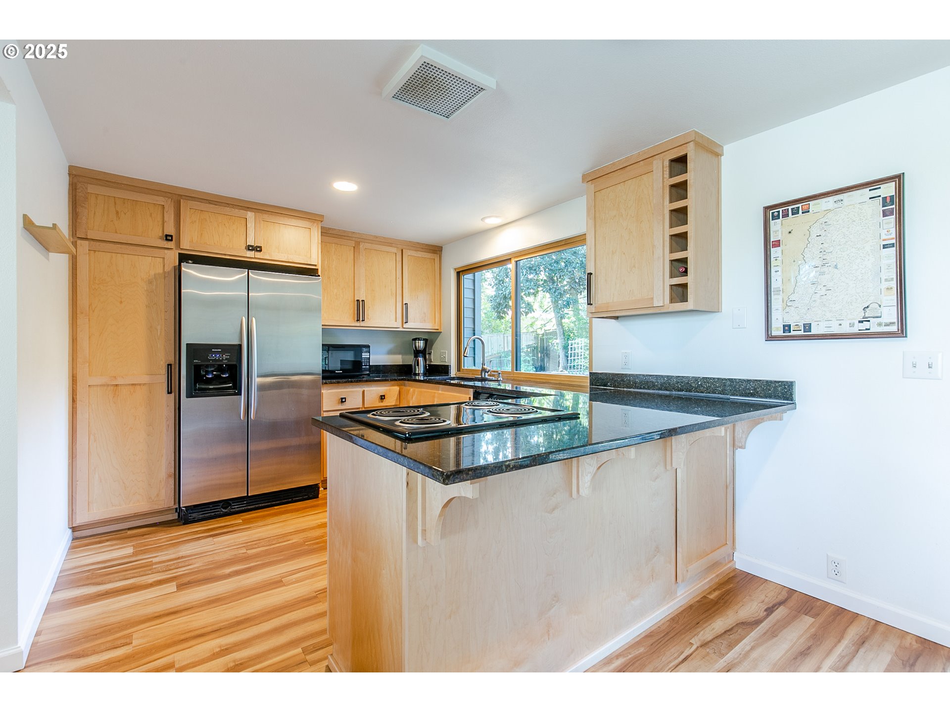 2724 Malibu Way Eugene, OR 97405 - Photo 20 of 48 a kitchen with stainless steel appliances granite countertop a refrigerator a sink dishwasher a stove and white countertops with wooden floor