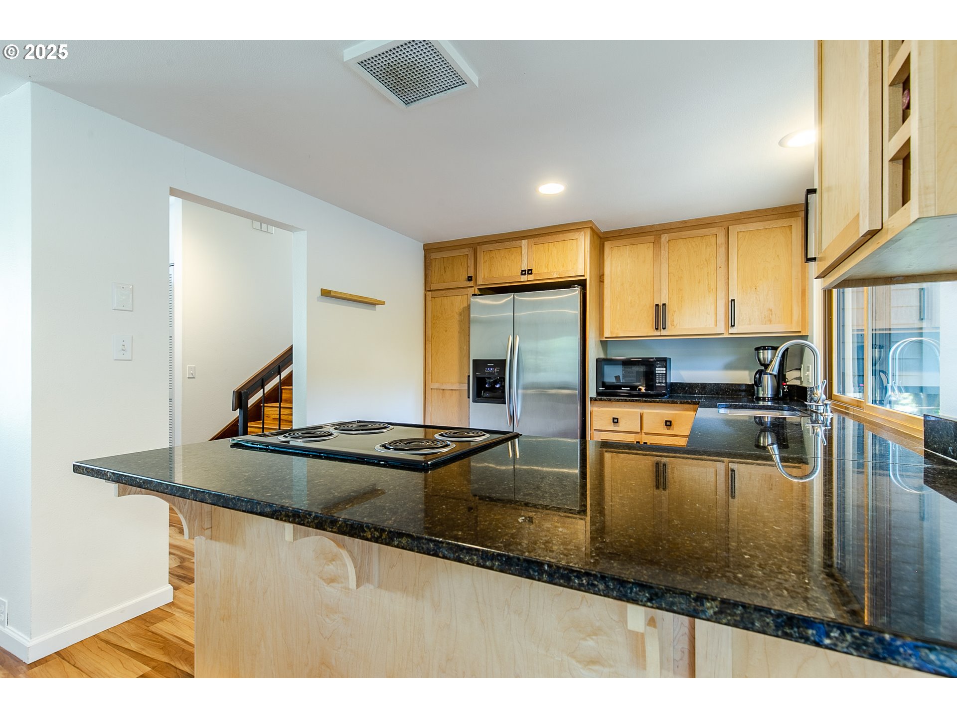 2724 Malibu Way Eugene, OR 97405 - Photo 21 of 48 a kitchen with kitchen island granite countertop a sink stove and refrigerator