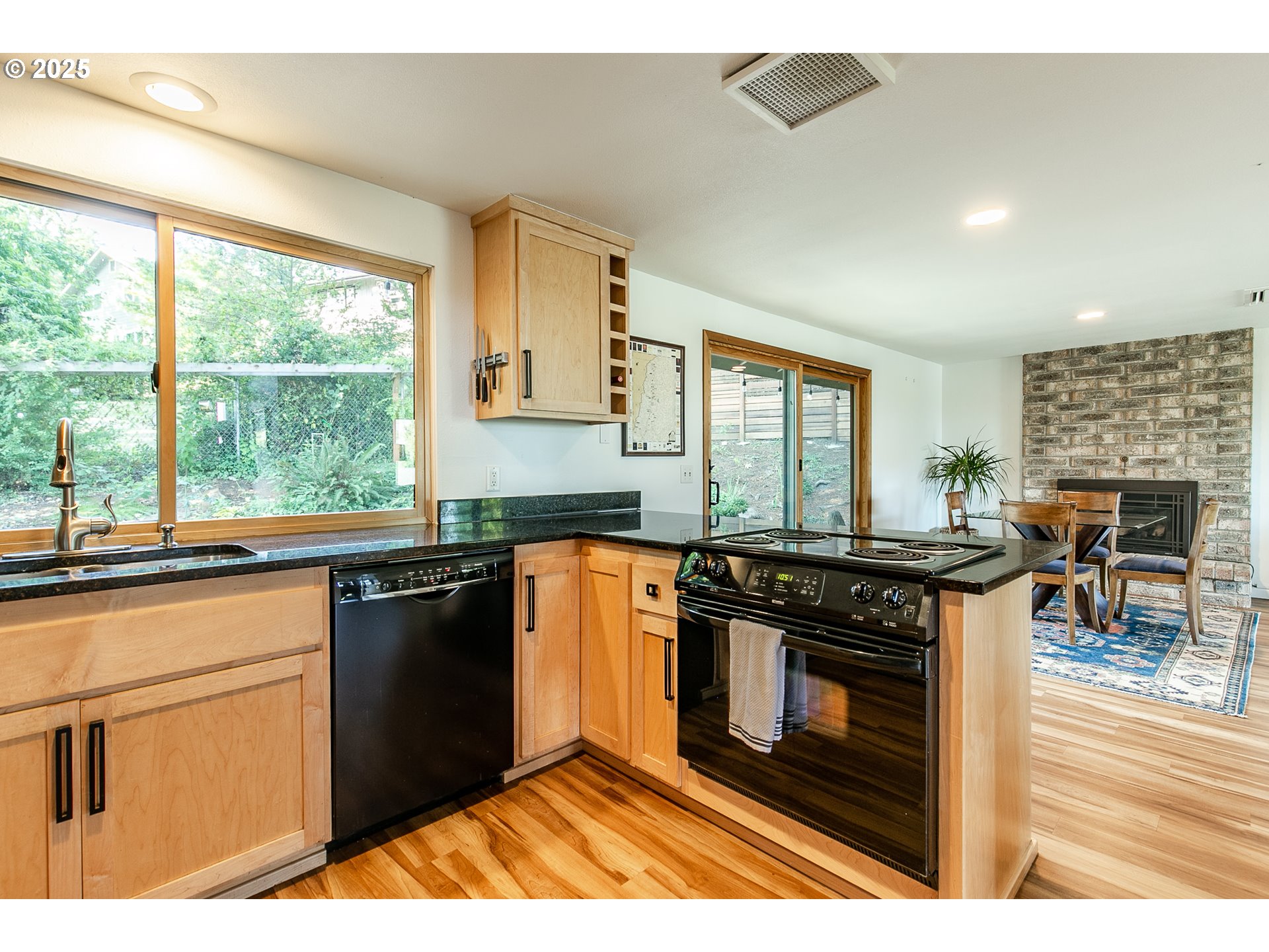 2724 Malibu Way Eugene, OR 97405 - Photo 22 of 48 a kitchen with stainless steel appliances granite countertop a stove a sink and a microwave
