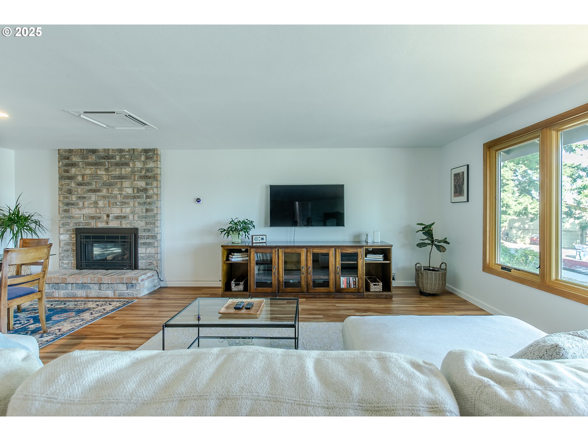 2724 Malibu Way Eugene, OR 97405 - Photo 7 of 48 a living room with furniture a fireplace and a flat screen tv