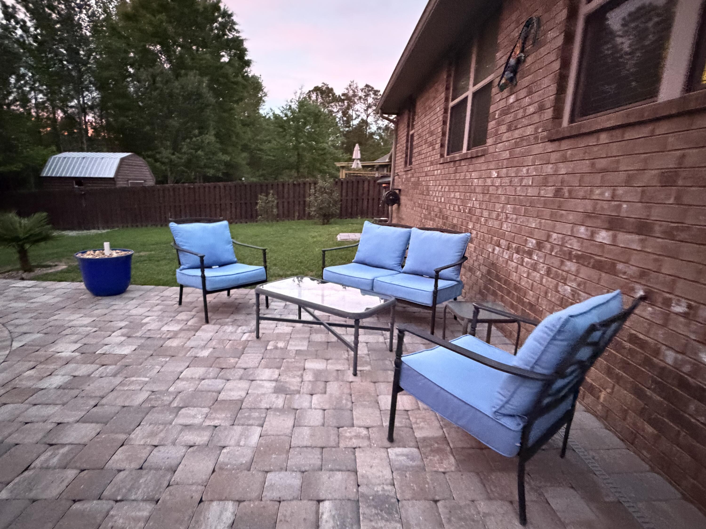 611 Terrier Trail Crestview, FL 32536 - Photo 13 of 64 a backyard of a house with outdoor seating