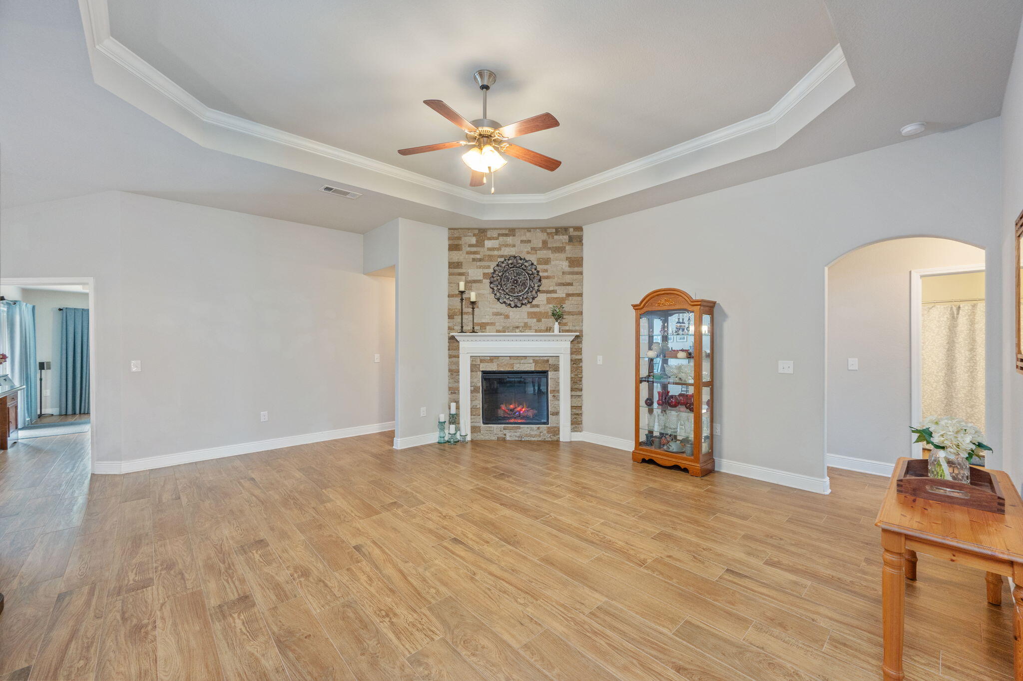 611 Terrier Trail Crestview, FL 32536 - Photo 29 of 64 a view of a livingroom with a fireplace a chandelier and wooden floor