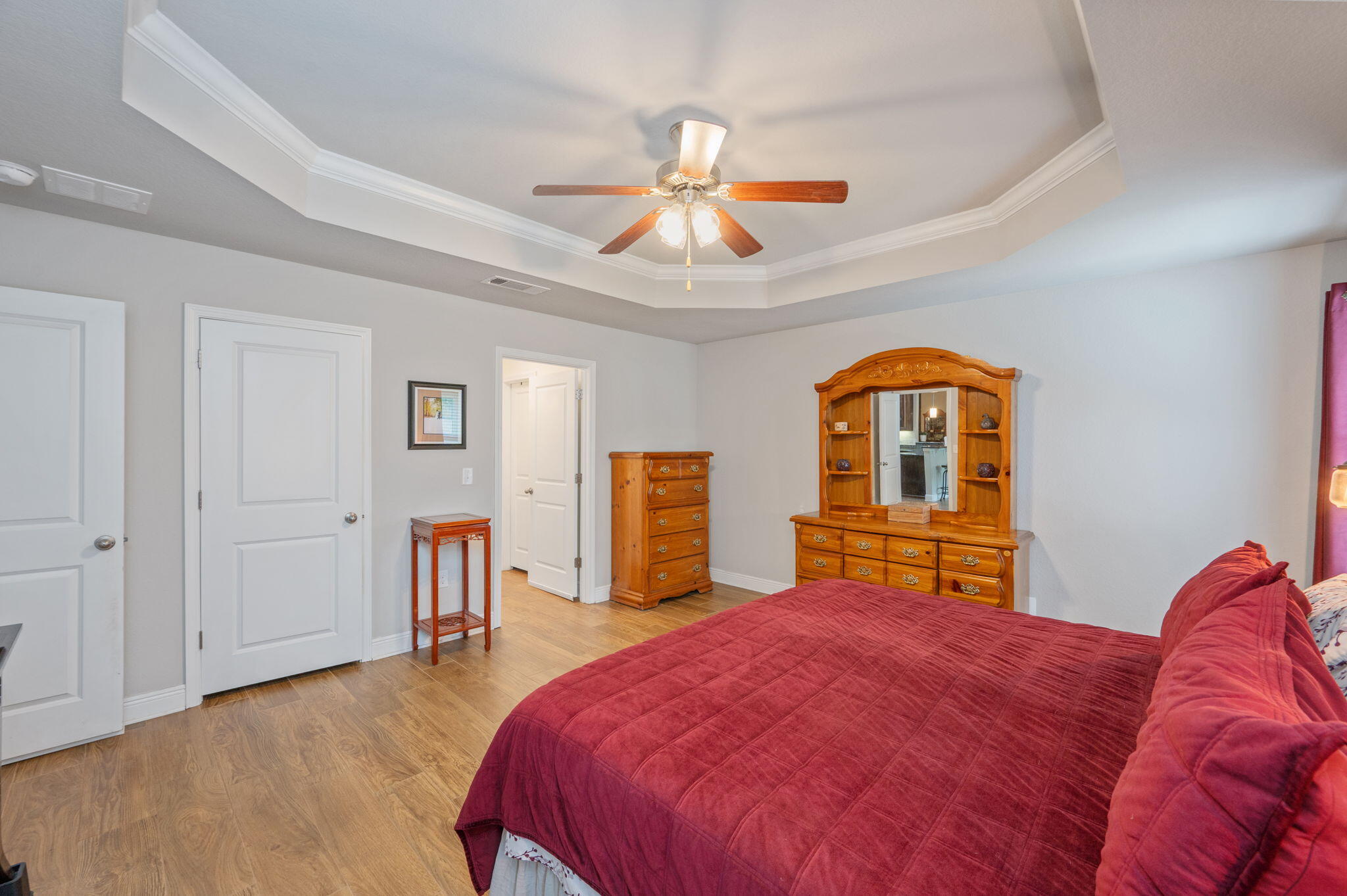 611 Terrier Trail Crestview, FL 32536 - Photo 45 of 64 a bedroom with a large bed and a chandelier