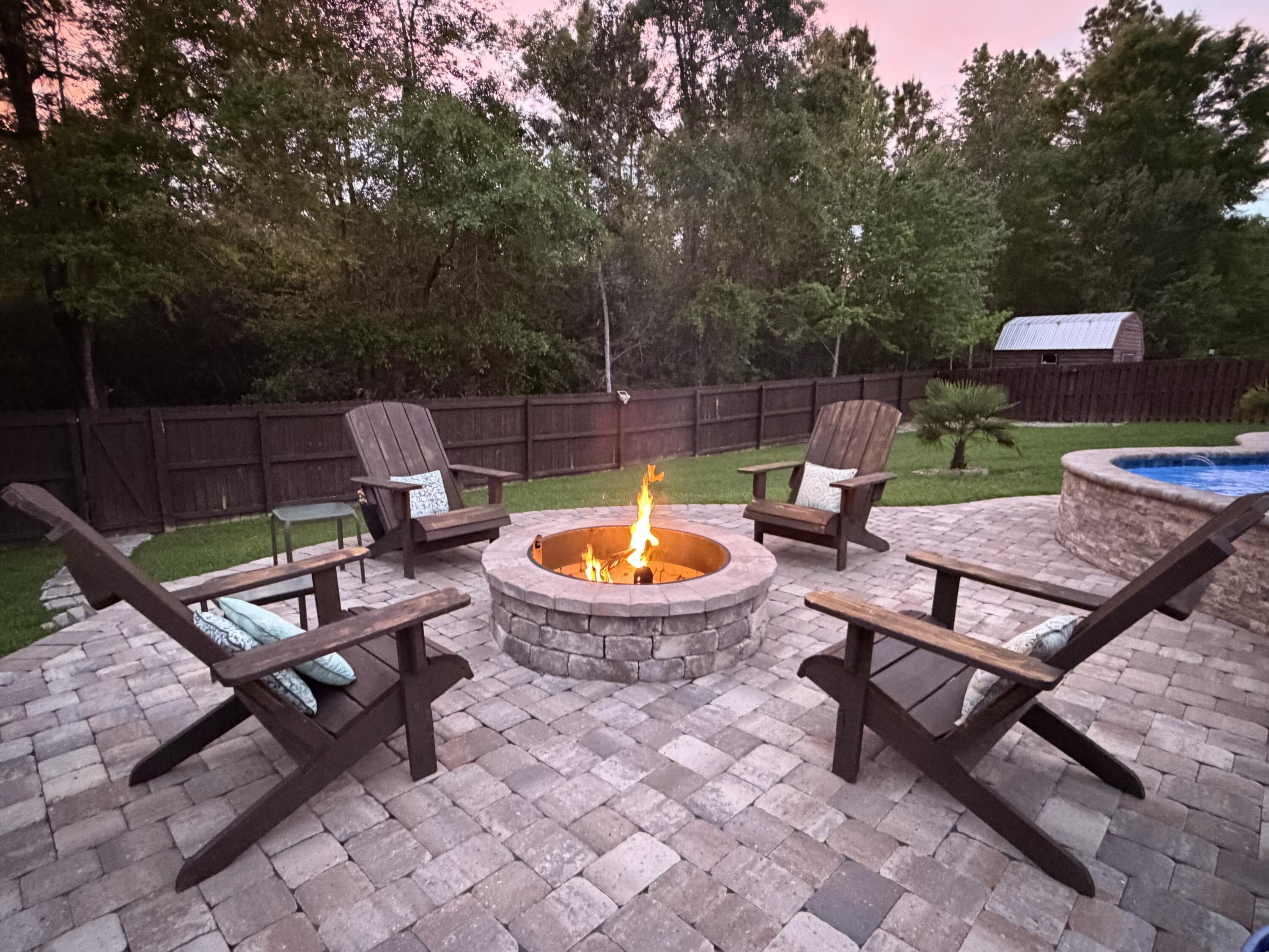611 Terrier Trail Crestview, FL 32536 - Photo 6 of 64 a view of a backyard with swimming pool and sitting area