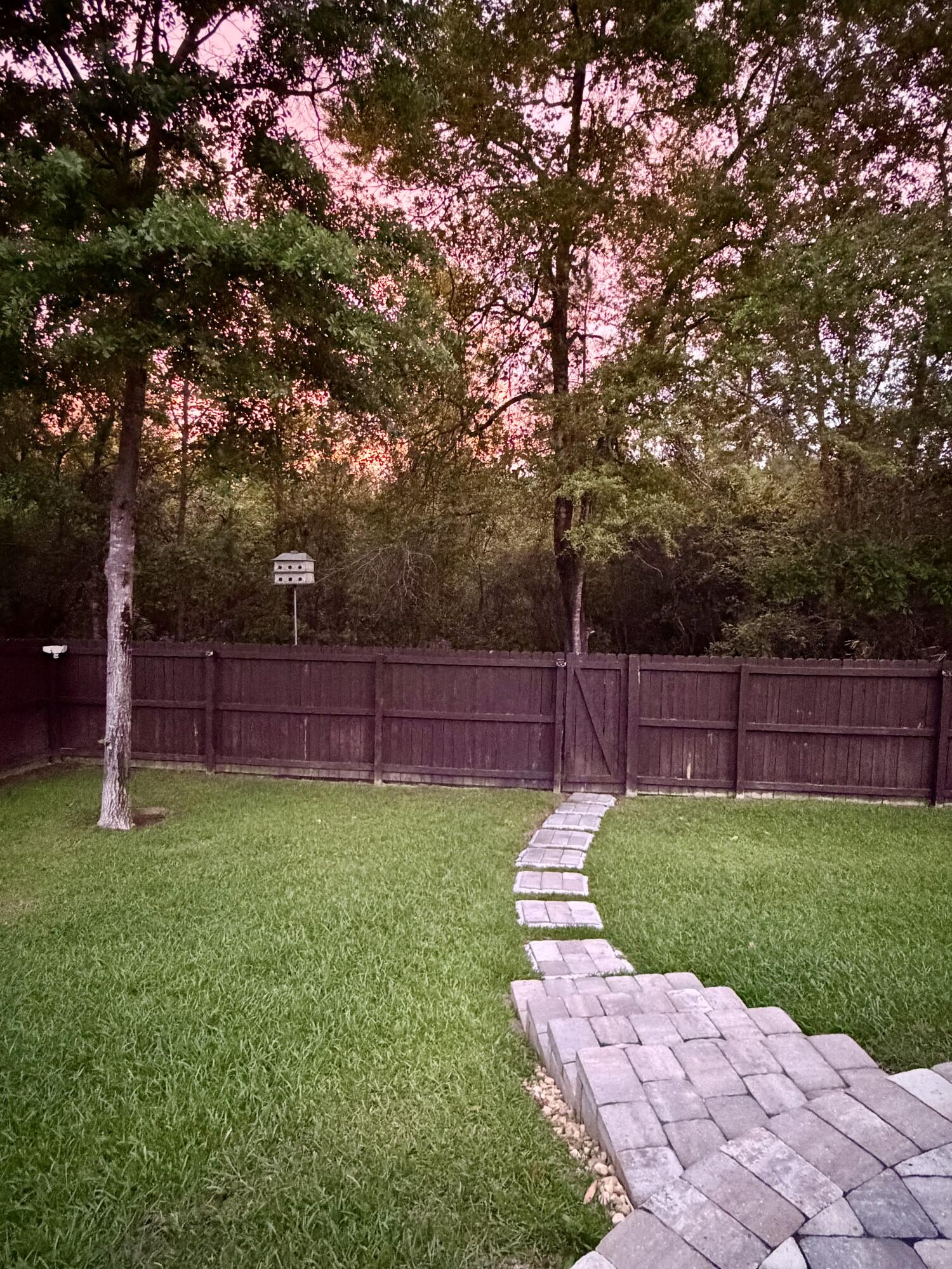 611 Terrier Trail Crestview, FL 32536 - Photo 61 of 64 a view of a backyard with wooden fence and a large tree