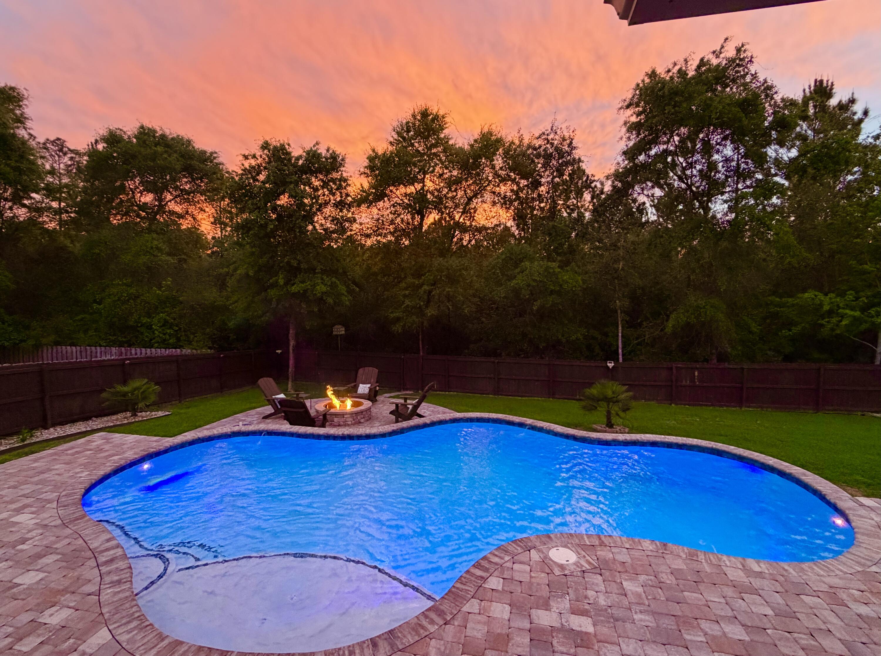 611 Terrier Trail Crestview, FL 32536 - Photo 62 of 64 a view of a swimming pool with an outdoor space and seating area
