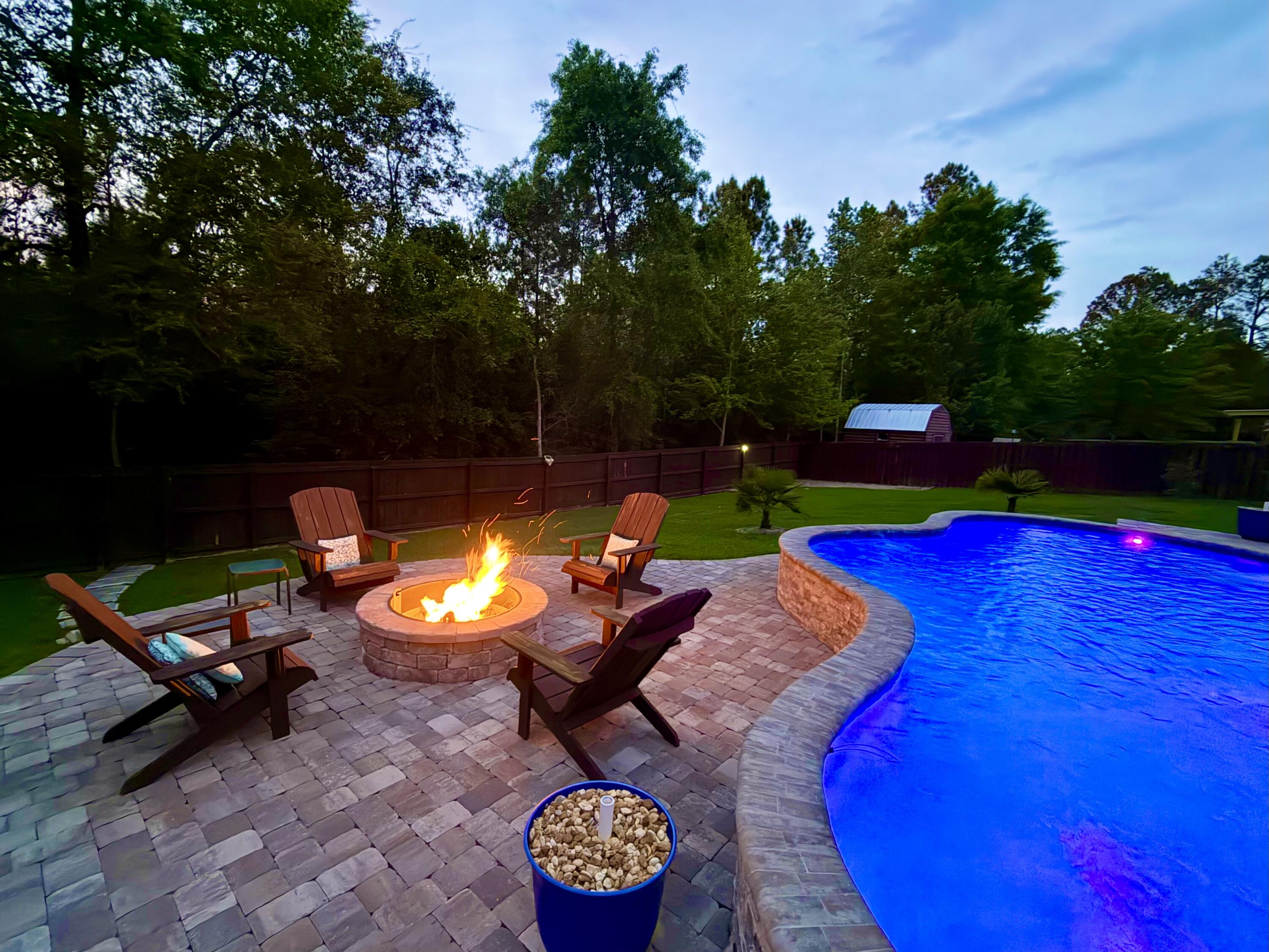 611 Terrier Trail Crestview, FL 32536 - Photo 10 of 64 a view of a swimming pool with a patio and a garden
