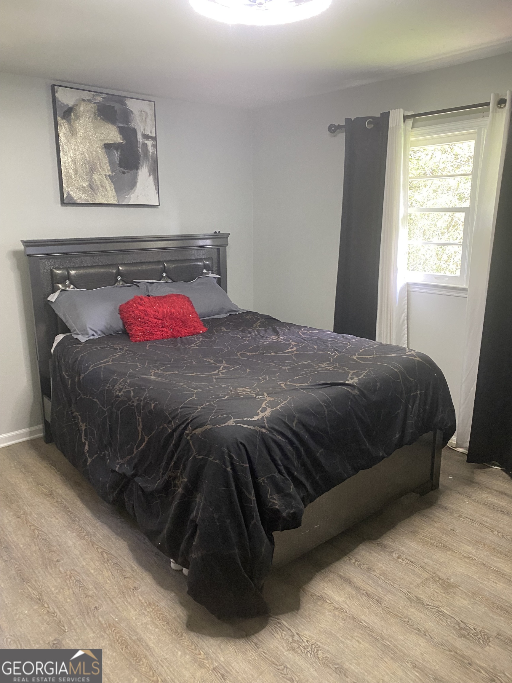 7383 Pleasant Hill Road Lithonia, GA 30058 - Photo 8 of 18 a bedroom with a bed and a couch