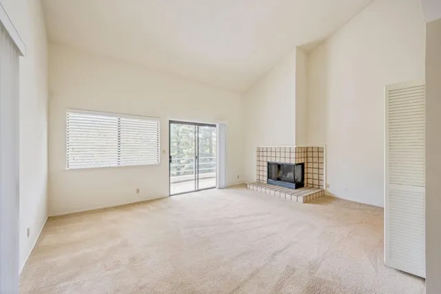 an empty room with furniture and a fireplace