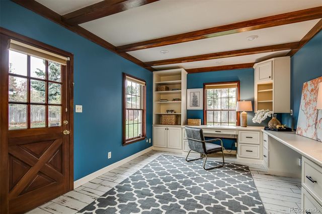 a view of a workspace with furniture and a window
