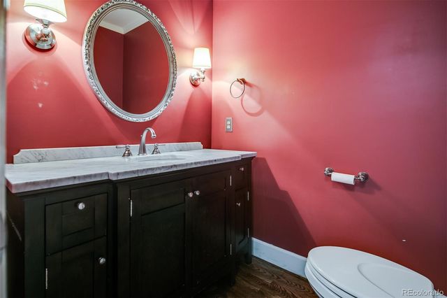 a bathroom with a sink mirror vanity and toilet