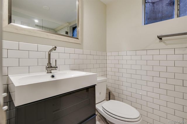 a bathroom with a sink a toilet and mirror