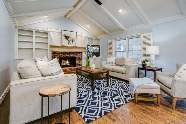 a living room with furniture a fireplace and a table