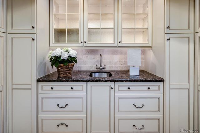 a white kitchen with granite countertop stainless steel appliances white cabinets and a granite counter tops