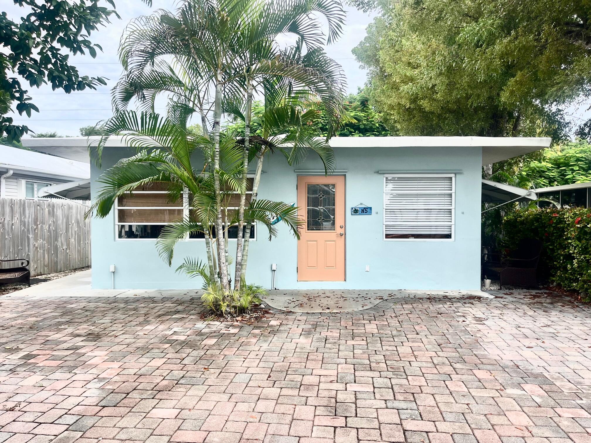 101620 Overseas Highway, Unit 5N Key Largo, FL 33037 - Photo 1 of 28 a front view of a house with a yard