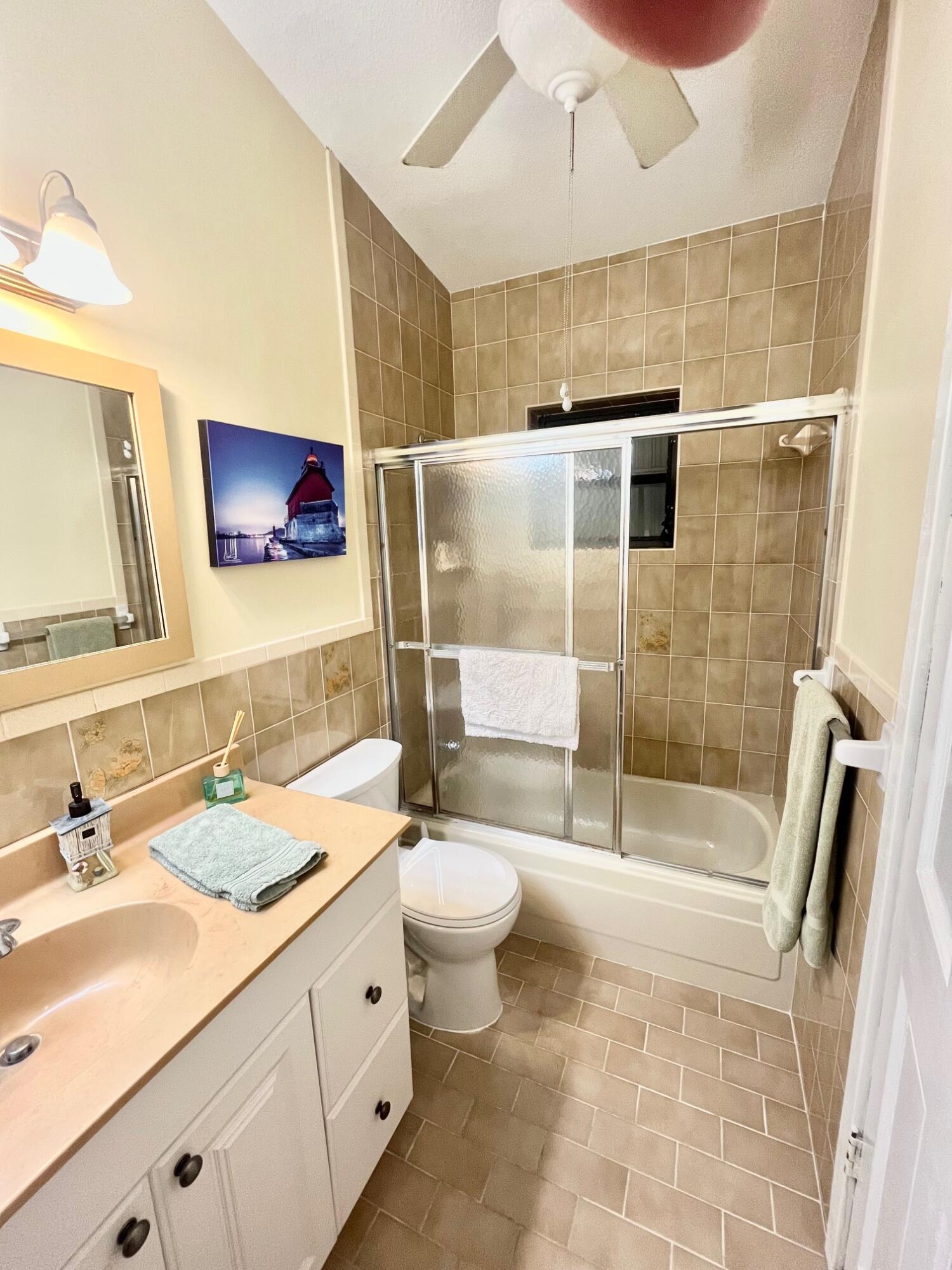 101620 Overseas Highway, Unit 5N Key Largo, FL 33037 - Photo 13 of 28 a bathroom with a sink a toilet and shower