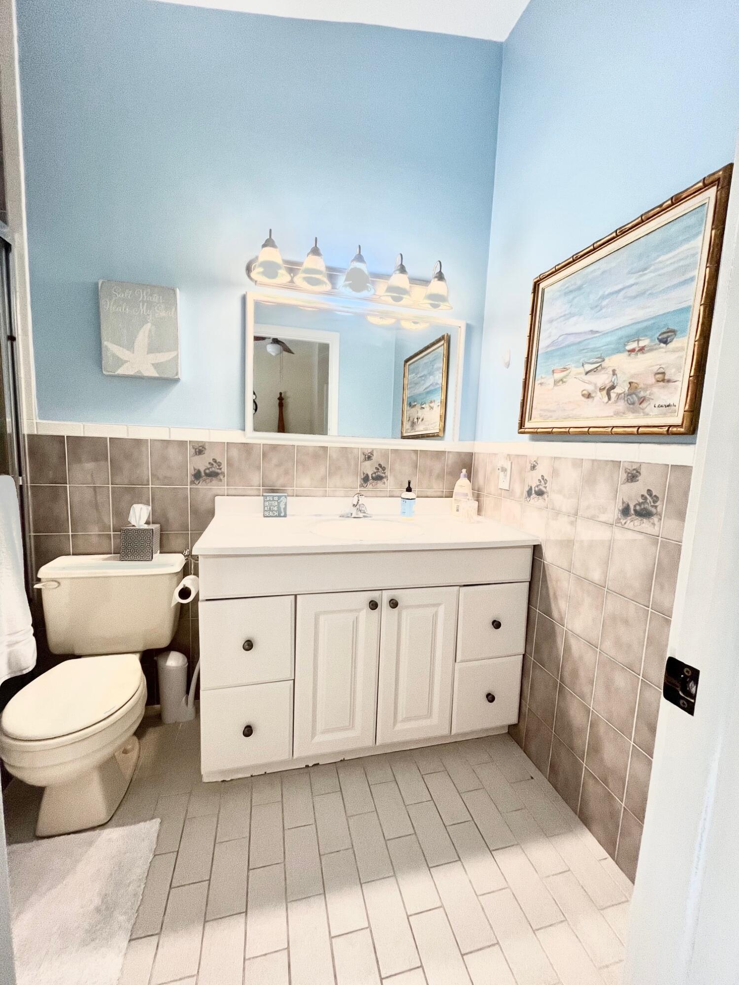 101620 Overseas Highway, Unit 5N Key Largo, FL 33037 - Photo 18 of 28 a bathroom with a sink toilet and mirror