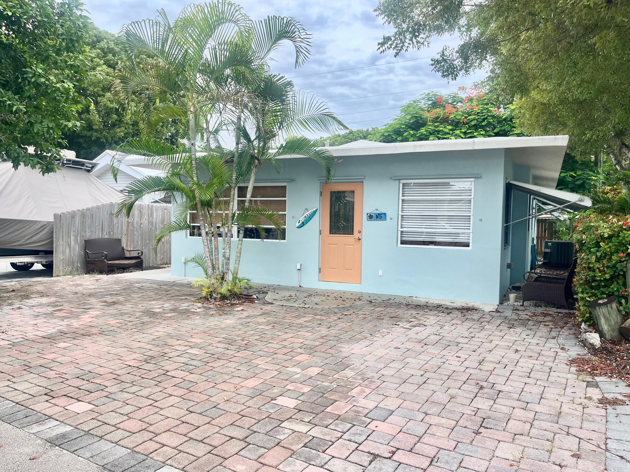 101620 Overseas Highway, Unit 5N Key Largo, FL 33037 - Photo 2 of 28 a view of a house with a garage