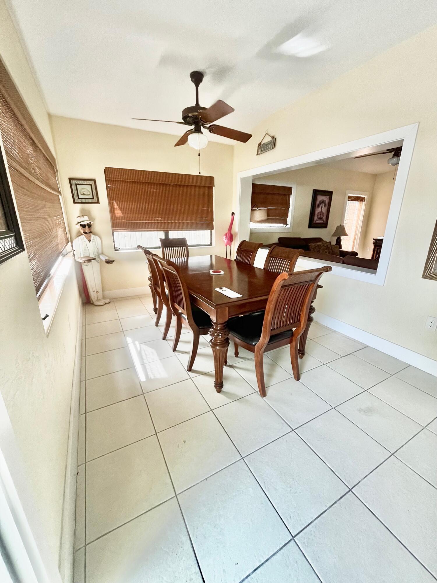 101620 Overseas Highway, Unit 5N Key Largo, FL 33037 - Photo 3 of 28 a living room with furniture a dining table and a fireplace